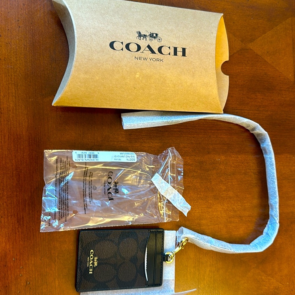 Tag ID/Cardholder. Brand new. Use it with the leather string/ neck or without.